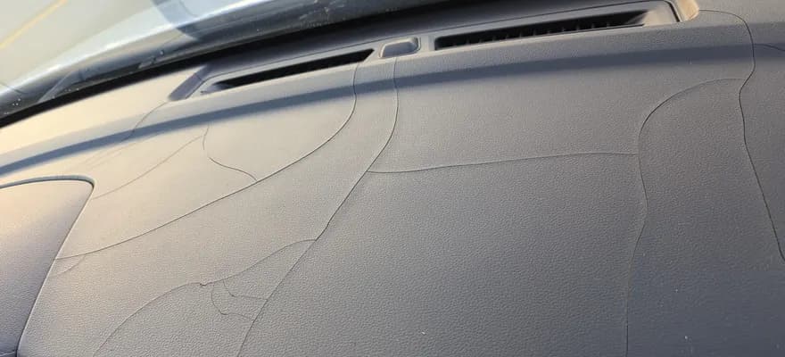 A dashboard cracked by years of sun through the windshield